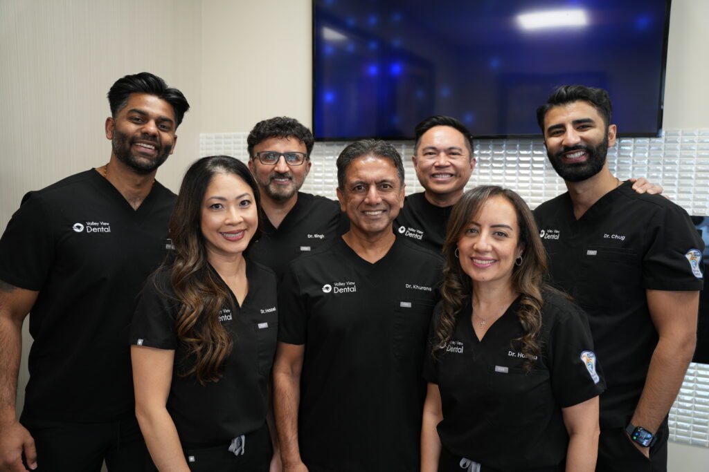 Best Dentist Near Me in Romeoville, local dentists smiling in photo in office in front of tv