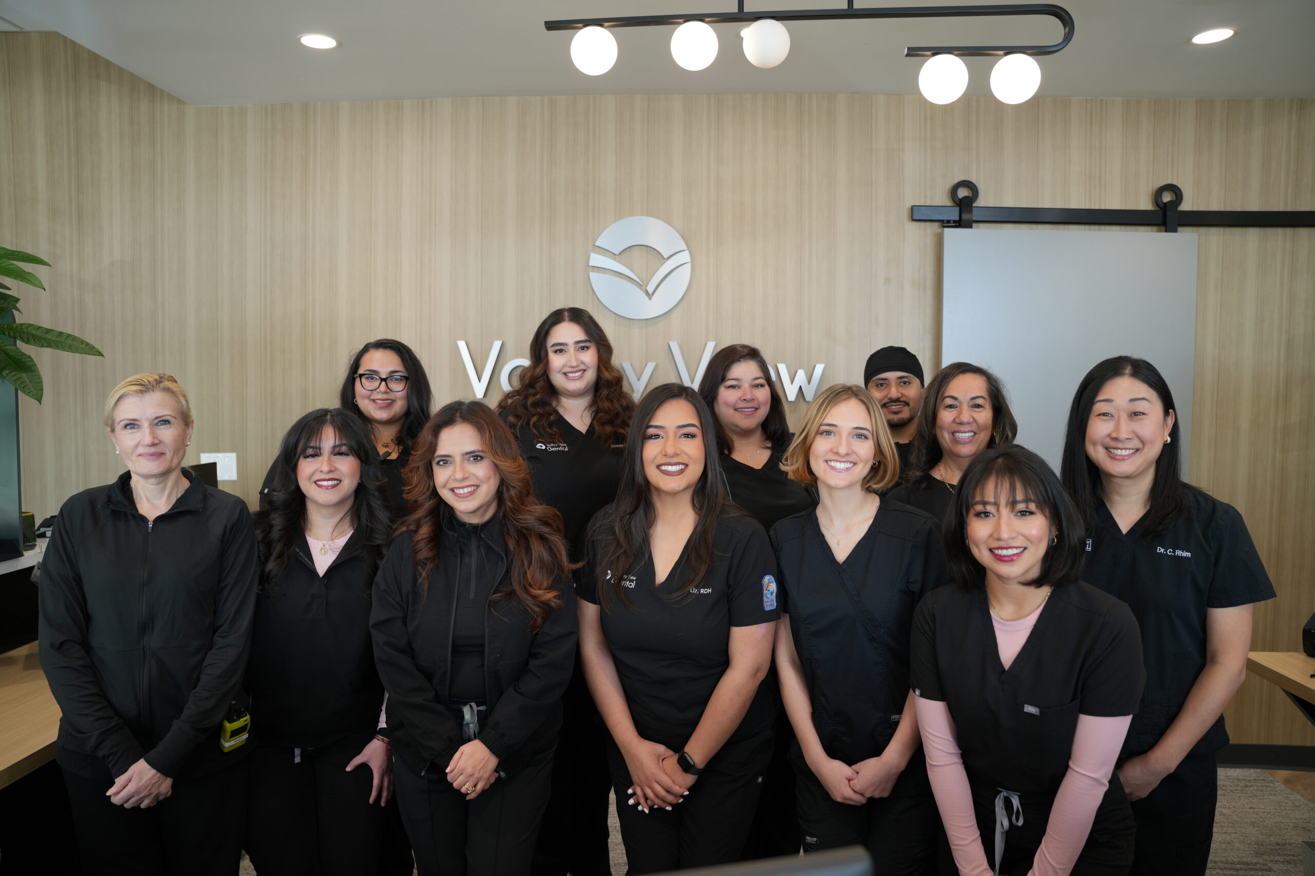 Dentist Near Me in Naperville Accepting New Patients friendly dentists and hygienists smiling in dental office