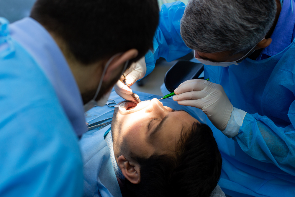 Emergency Tooth Extraction in Naperville - dentists in blue attire extracting teeth from patient
