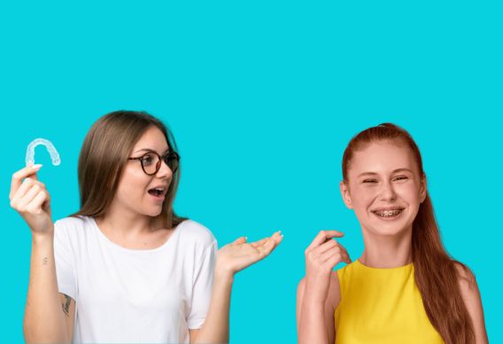 Teen Orthodontics in Naperville - Girl holding Invisalign tray and another girl smiling with braces