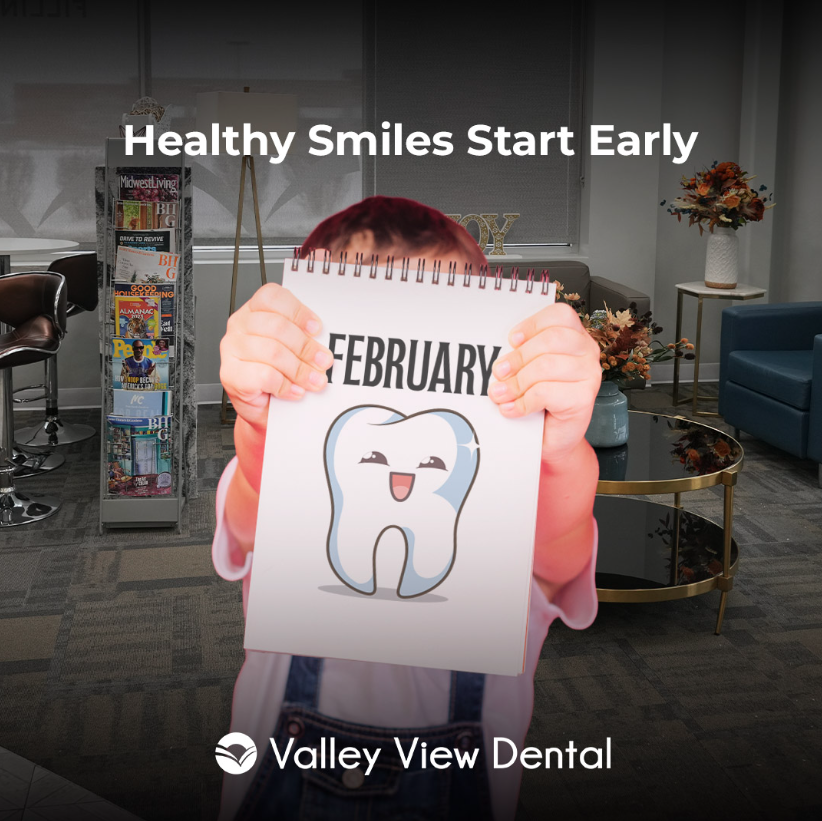 small kid holding february board with tooth illustration at Valley View Dental