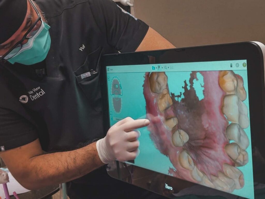Dental assistant viewing digital scan for same-day dental crowns in Romeoville, IL Valley View Dental office
